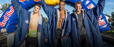 Team of three athletes wearing Red Bull branded dryrobe® Advance 