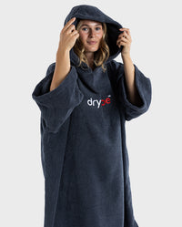 Woman wearing Navy Blue Organic Towel dryrobe® with hood up 