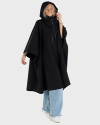 Woman smiling wearing Black dryrobe® Waterproof Poncho with hood up