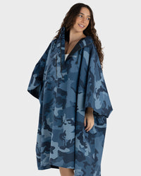 Woman wearing  Blue Camo dryrobe® Waterproof Poncho unzipped with hood down 