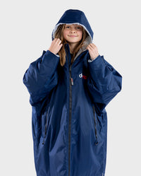 Girl wearing Navy Grey dryrobe® Advance Kids Long Sleeve zipped with hood up 