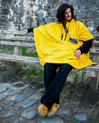 *MALE* sat on a bench wearing  Yellow dryrobe® Waterproof Poncho