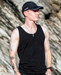 1|Man stood in the sun in front of rocks, wearing black dyrobe® quick dry cap 