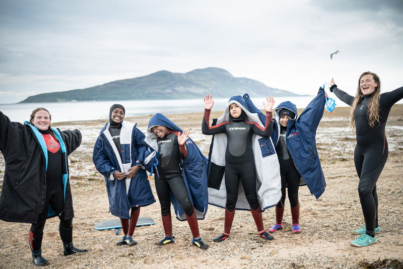Cal Major stood on the beach with children on the Seaful pilot wearing dryrobes 