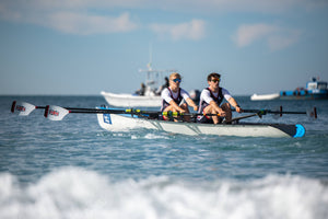 A pair of rowers in rowing in the sea doing Beach Sprints 