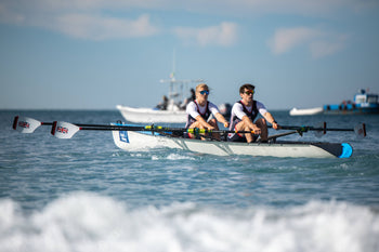 A pair of rowers in rowing in the sea doing Beach Sprints 