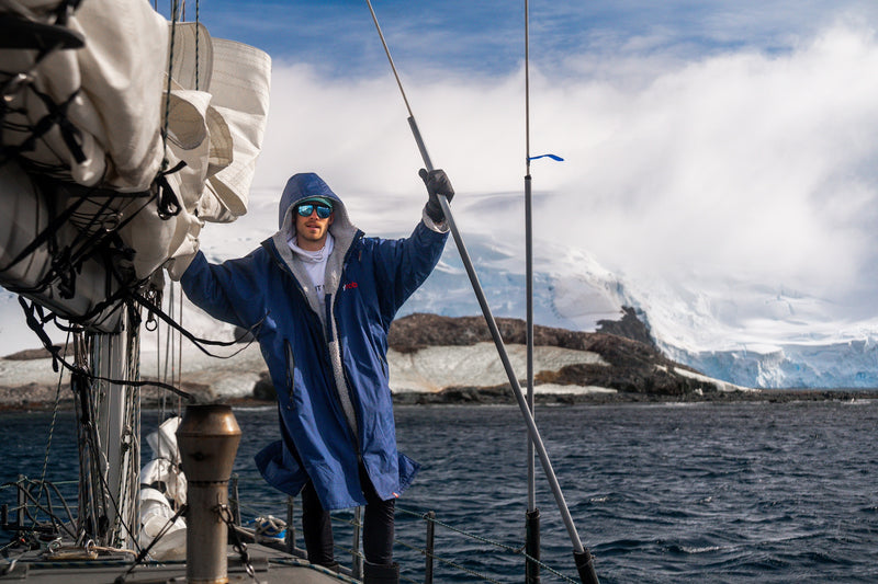 Man stood on a boat in a dryrobe