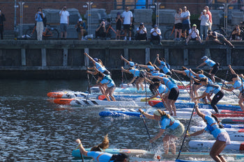 SUPers paddling in a canal at the start line of the 2024 ISA World SUP and Paddleboard Championship 