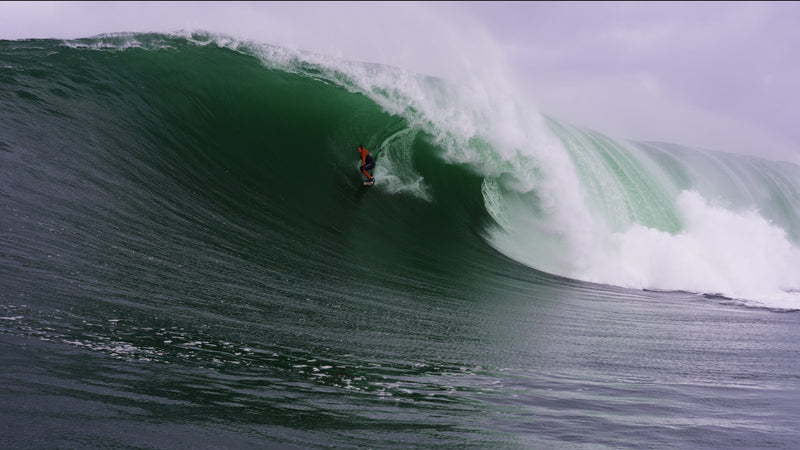 Andrew Cotton surfing a big wave in Ireland