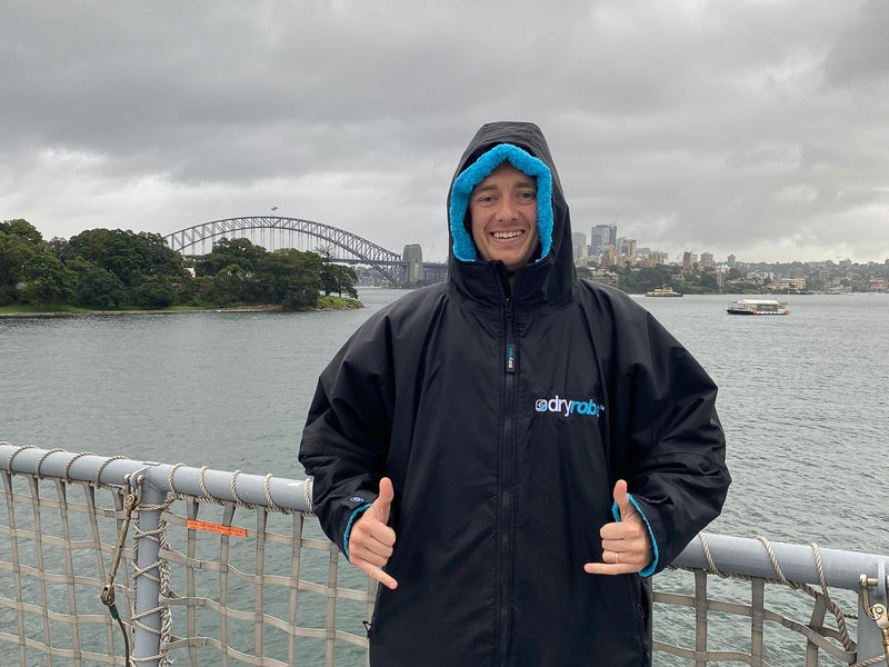 Lifeguard Maxi doing two thumbs up wearing a black dryrobe® Advance 