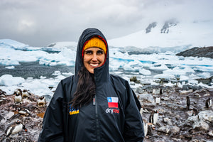 Ice marathon swimmer Bárbara Hernández Huerta smiling in a dryrobe with snow in the background