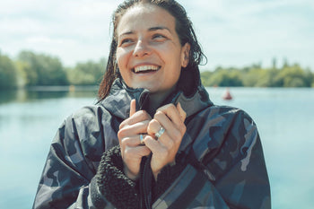 dryrobe® Ambassador Keri-anne Payne  smiling and holding her change robe before swimming in a lake 