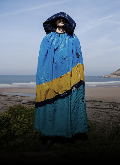 Man stood on the beach wearing the first prototype dryrobe®