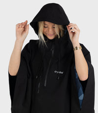 Woman wearing Black dryrobe® Waterproof Poncho with hood up 