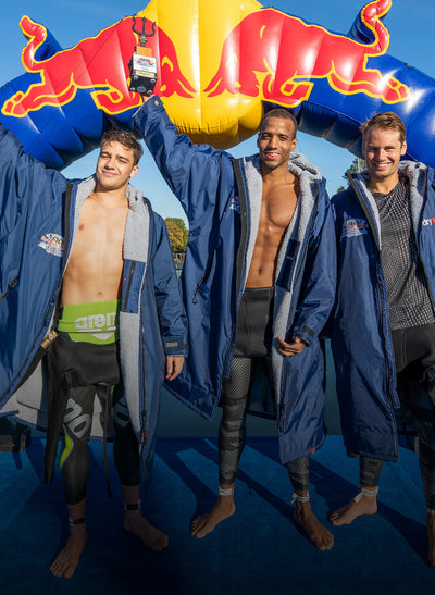 Team of three athletes wearing Red Bull branded dryrobe® Advance 