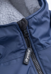 Close-up of a blue Dryrobe® jacket with a zipper and brand logo.