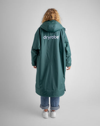 Female in studio wearing AW25 Green Dryrobe® advance long sleeve 