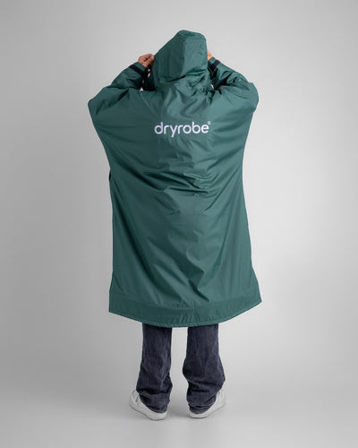 *MALE* in studio wearing AW25 Green Dryrobe® advance long sleeve 