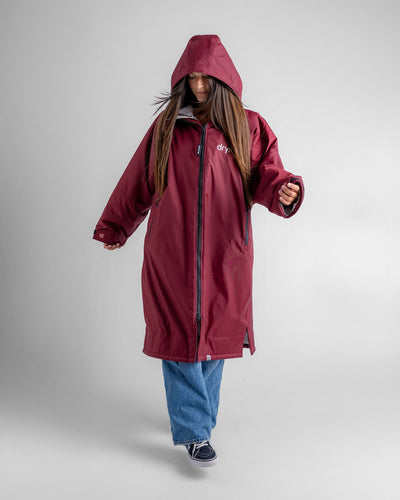 Female in studio wearing AW25 Burgundy Dryrobe® advance long sleeve 