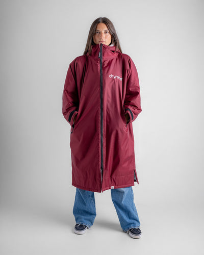 Female in studio wearing AW25 Burgundy Dryrobe® advance long sleeve 