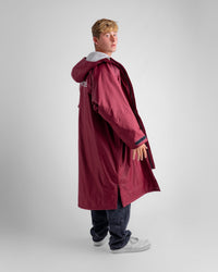 *MALE* in studio wearing AW25 Burgundy Dryrobe® advance long sleeve 