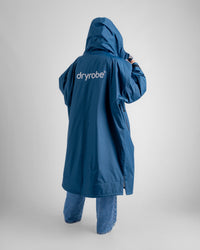 Female in studio wearing AW25 Blue Dryrobe® advance long sleeve 