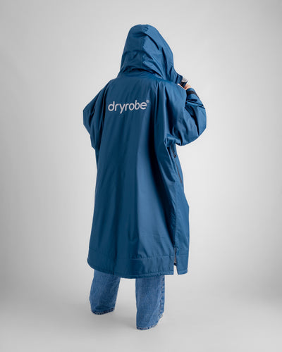 Female in studio wearing AW25 Blue Dryrobe® advance long sleeve 