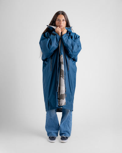 Female in studio wearing AW25 Blue Dryrobe® advance long sleeve 