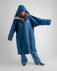 Female in studio wearing AW25 Blue Dryrobe® advance long sleeve 