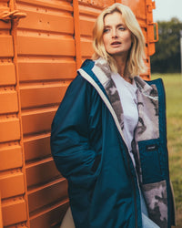 Woman outside in field wearing AW25 Blue Dryrobe® advance long sleeve 