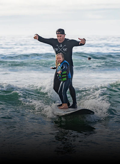 Adult and child surfing