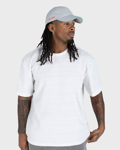 male in studio wearing grey Dryrobe® water resistant cap 