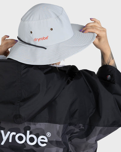 Female in studio wearing grey Dryrobe® water resistant wide brimmed hat 
