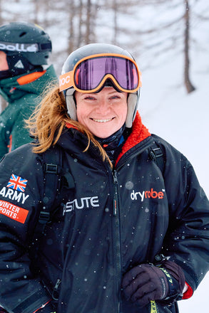 Person wearing a dryrobe with visible branding in a snowy outdoor setting