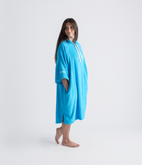 Woman wearing a blue towel robe with a brand logo on a white background