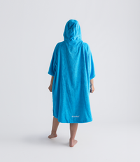 Person wearing a blue hooded towel robe on a white background