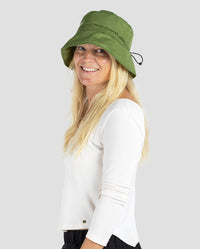 Woman smiling wearing dryrobe Fleece Lined Bucket Hat in Forest Green 