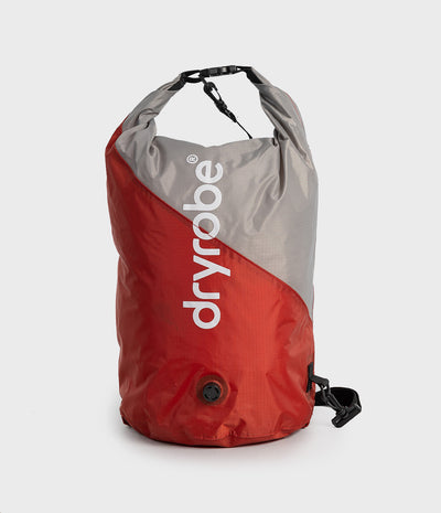 A Dryrobe waterproof dry bag in red and gray with white vertical branding, shown on a light gray background.