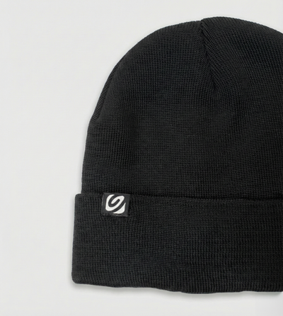 Black beanie with a logo on a light gray background