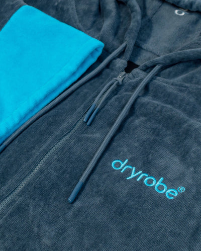 Blue hooded towel robe with 'dryrobe' logo on a grey background