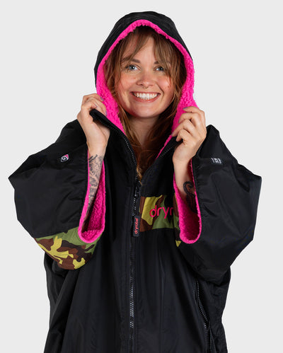 Adult female in studio wearing Dryrobe® Black pink camo remix