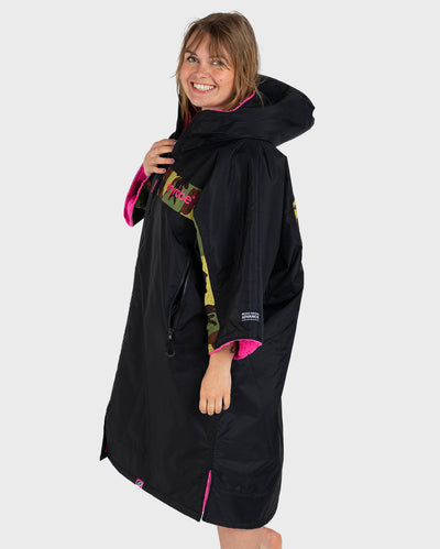 Adult female in studio wearing Dryrobe® Black pink camo remix