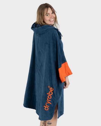 Female in studio wearing Dryrobe® Zip towel (blue orange)