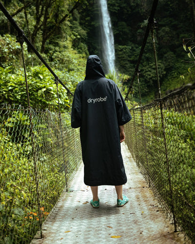 Female in front of waterfall wearing Tech-Lite Dryrobe®
