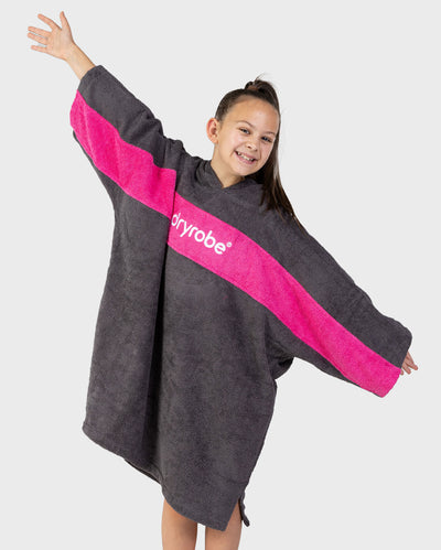 Girl wearing Kids Organic Towel dryrobe - Remix in Slate Grey Pink holding arms out
