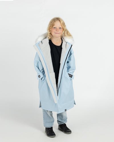 Child wearing dryrobe Advance Long Sleeve Alpine Range changing robe in Alpine Ice Blue