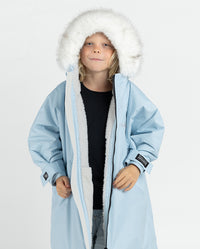 Child wearing dryrobe Advance Long Sleeve Alpine Range changing robe in Alpine Ice Blue with hood up 