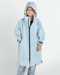 Child wearing dryrobe Advance Long Sleeve Alpine Range changing robe in Alpine Ice Blue with fur trim detached