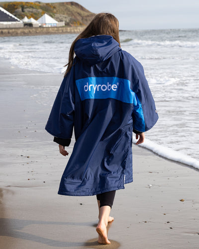 Kids navy cobalt Dryrobe® remix on beach