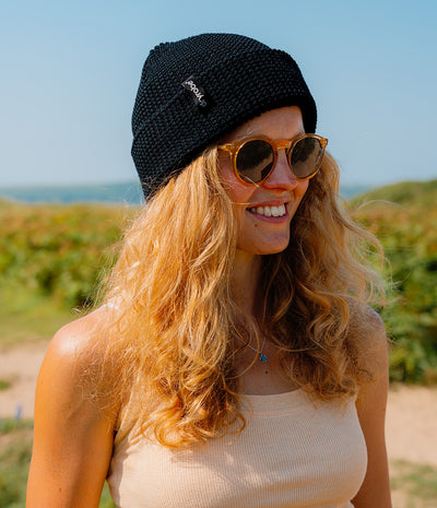 women wearing a black beanie with 'dryrobe' logo